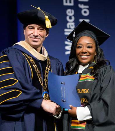 Nuno Takes Picture with 2025 Graduate